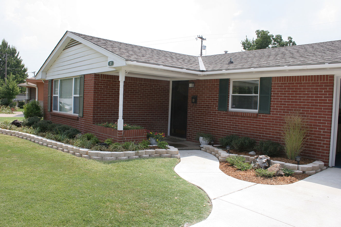 Landscape installation with stone edging and layered planting